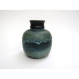 A Ruscha West German Pottery vase with mottled blue glazes. No. 876 to base. 16.