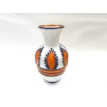 An Italian Pottery floor vase in white glaze with orange and blue relief foliate detail.
