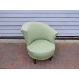 A Danish 1940s low tub chair with swept back rest, original green wool upholstery,