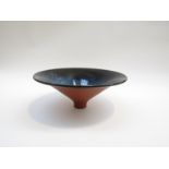 A studio earthenware pedestal bowl of slender tapering form, mottled blue glazed interior.