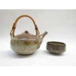 An Aylesford pottery bowl and similar tea pot with iron rich glazes.