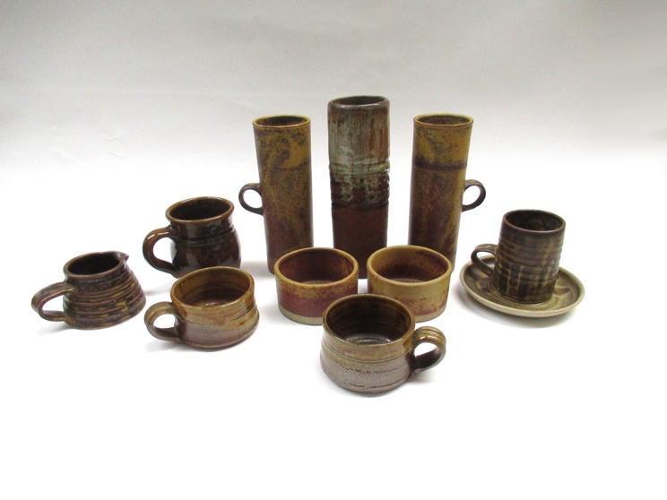 A collection of studio pottery to include Robin Welch tankards (chip to handle of one),