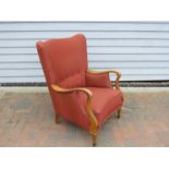 A Danish 1940s beech framed armchair with original red upholstery,