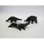 Three vintage matt black pottery dinosaur figurines,