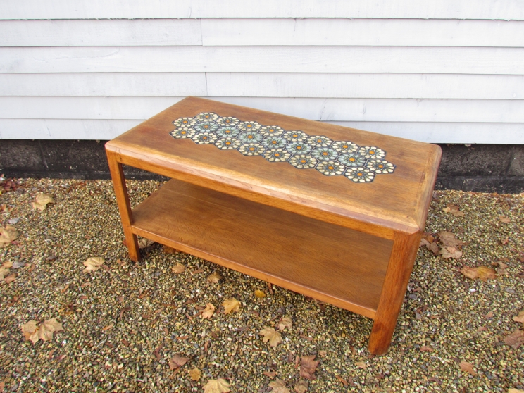 GEORGE SNEED (b.1927) An oak two tiered coffee table with inset tiled top.