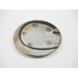 LISA HAMMOND (b.1956): A Studio Pottery plate, black clay with lustred shino shell decoration.