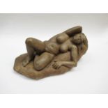 A painted plaster sculptural figure of a reclining female nude.