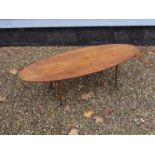A 1950's oak eliptical top coffee table on tapering legs. 118.