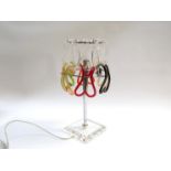 A Murano glass and stainless steel table lamp with shaped links in clear, red,