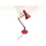 A red "anglepoise 90" adjustable lamp by Anglepoise Lighting Ltd.