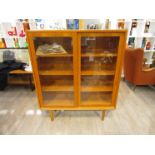 A Danish teak display cabinet with twin glazed sliding doors, shelved interior,