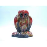 ERIC LEAPER (Newlyn XX): An unmarked pottery figure of an owl with orange and treacle glazes. 26.
