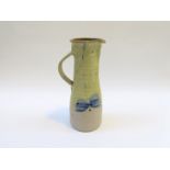 A Studio pottery tall jug with painted dragonfly detail. No seal.