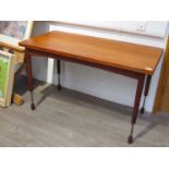 A teak combined coffee/ dining table with extending legs, swivel and folding leaf top,
