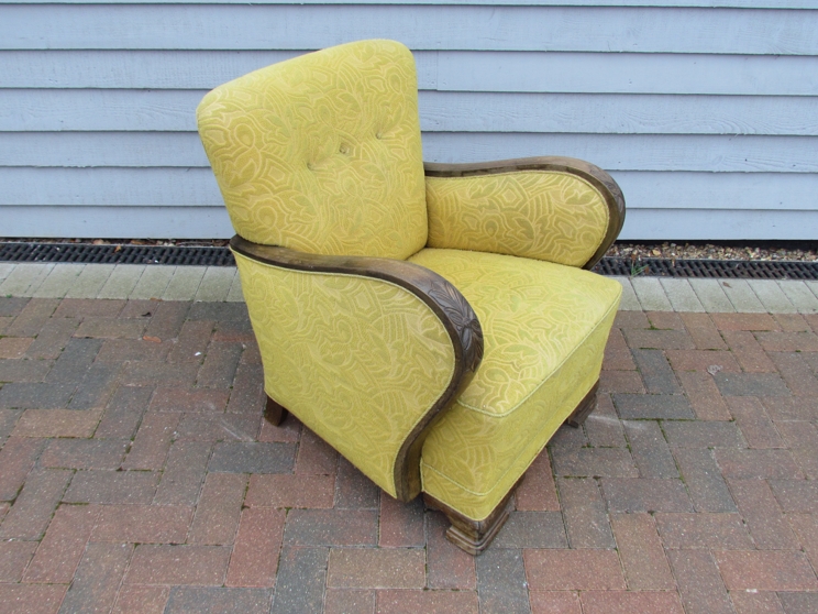 A Danish 1940s oak framed armchair with lime green foliate embossed upholstery,