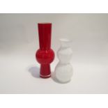Two art glass vases in red and in white, mould blown forms encased in clear.