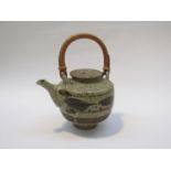 HUGH WEST (b.1950): A Studio Pottery lidded teapot, brush work detail. Cane handle.