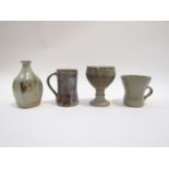 A collection of studio ceramic mugs and vases etc in leach standard waves.
