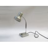 A small desk light in grey and chrome,