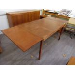 A Danish teak Stole Mobelfabrik dining table with drop ends raised on squared legs,