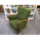 A Danish 1940s oak framed armchair with original green floral embossed upholstery,
