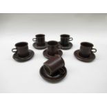 An Arabia brown glazed set of six coffee cans and saucers