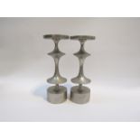 A pair of aluminium candle stands,shaped disc stems.