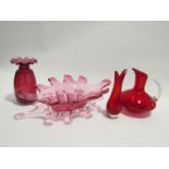 A collection of ruby and cranberry glass including Whitefriars jug and stem vase etc.