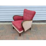 A Danish 1940s low armchair, dark stained hardwood frame, original red and cream upholstery,