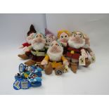 A set of seven Walt Disney dwarf beanie toys and five nail brushes.