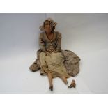 A cloth bodied European boudoir doll with painted face in original dress,