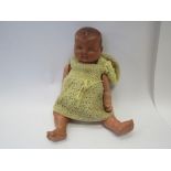 An early 20th Century jointed composition doll