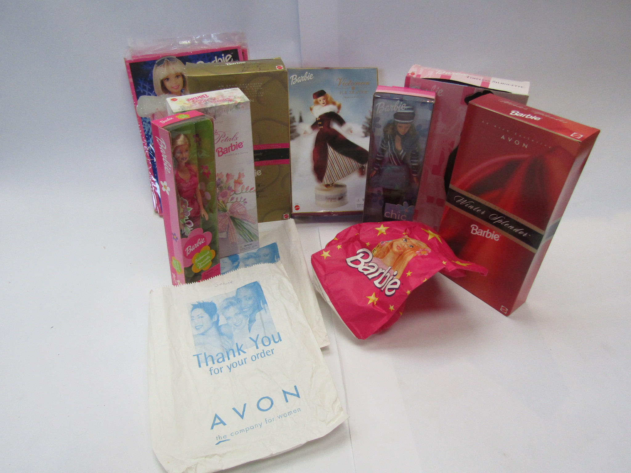 A collection of Barbie dolls including Avon