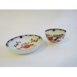 A Lowestoft porcelain Imari coloured tea bowl painted with iron red flowers and blue leaves,