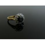 An 18ct gold sapphire and diamond cluster ring. Size J/K, 4.