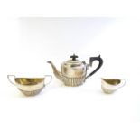A matched silver three-piece bachelor's tea set consisting of teapot, sucrier and milk jug,