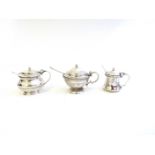 Three silver mustard pots including Roberts and Bell with beaded rim.
