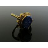 A gold Sasanian style ring with oval lapis intaglio of a walking cherub, 5.