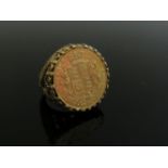 An 1842 gold sovereign ring in 9ct gold ornate pierced shank. Size N, 16.