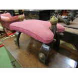 An Eastern hardwood camel stool, stuffed pink upholstery,