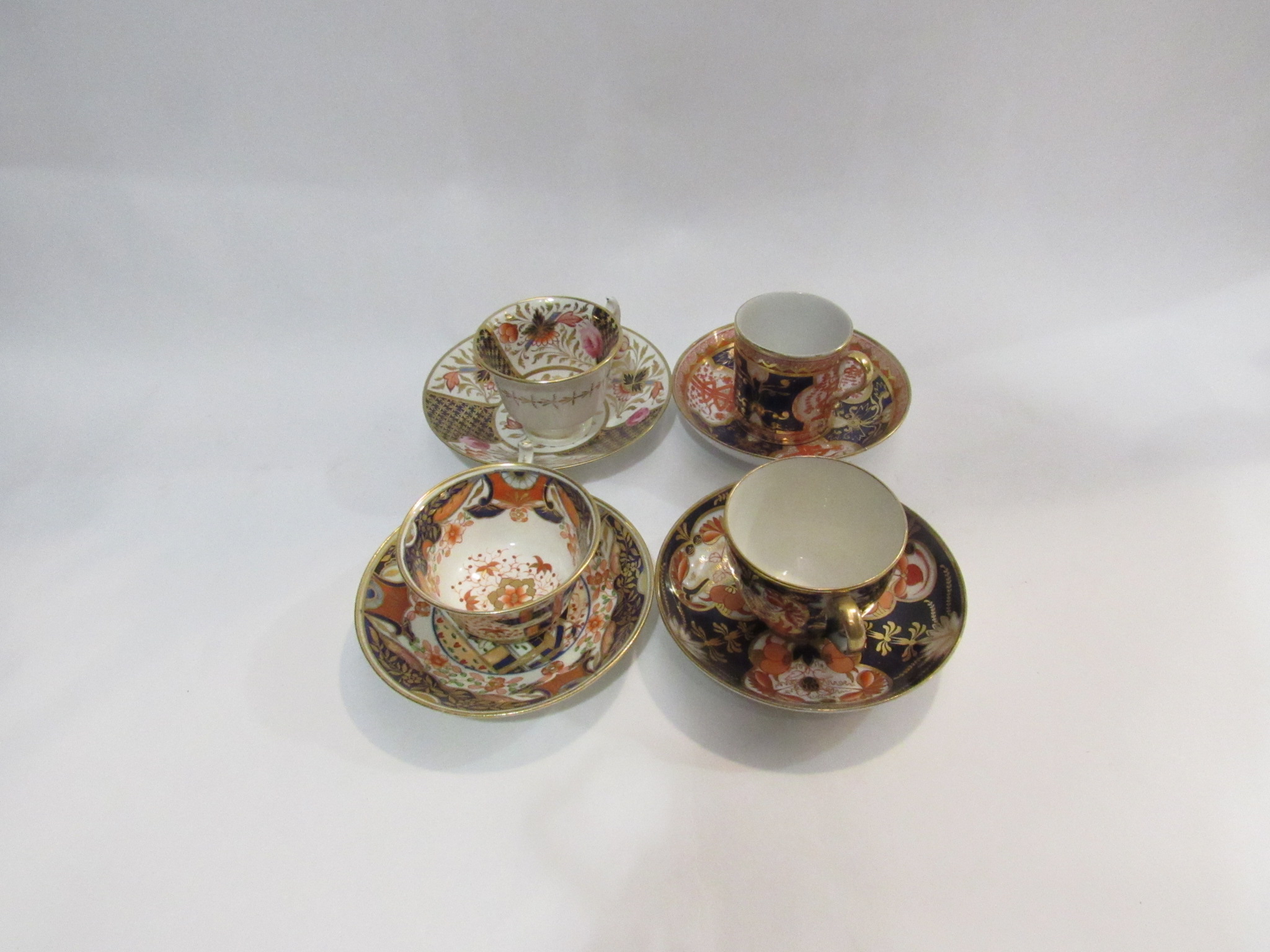 Four late 18th/early 19th Century cups and saucers in imari palette.