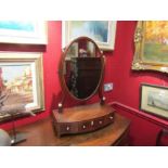 A George III crossbanded mahogany dressing chest oval mirror with bone handles to a three drawer