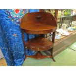 A George III mahogany bow front three tier washstand with single drawer over outswept legs