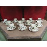 A collection of Chinese porcelain coffee cups and saucers,