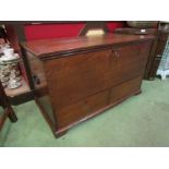 A George III oak mule chest with exposed dovetail joints the hinged lid over two base drawers with