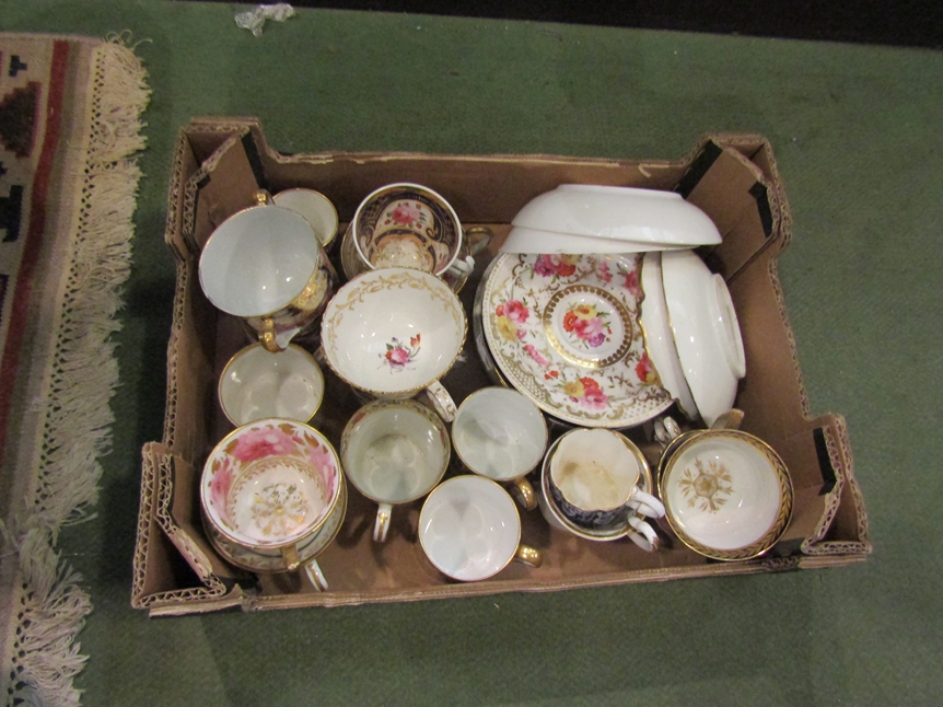 A box containing a quantity of assorted late 18th/early 19th Century cups and saucers,