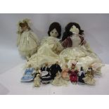 A collection of mixed cloth and bisque dolls