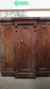 A Victorian mahogany 3 door combination wardrobe with 3 drawers in centre section.