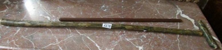 A two piece walking cane with badge reading Sir Jeffrey Hillpig-Smyth, British East India,