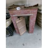 An old brick built model of a building with corrugated roof (probably an outside toilet).